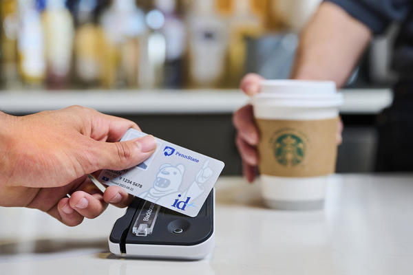 Person using their id+ card at a tap to pay station