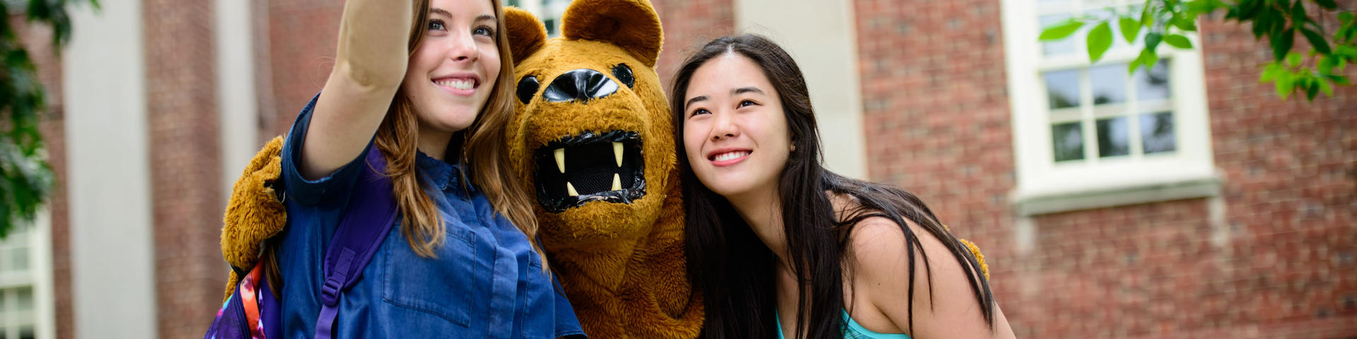 Students taking a selfie with the Penn State mascot